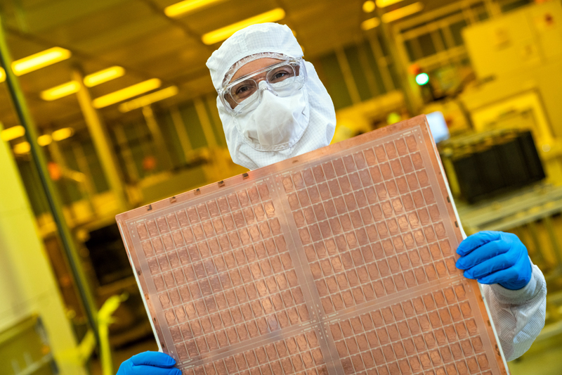 An Intel engineer holds a test glass core substrate panel.