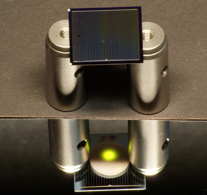 A two-sided silicon solar cell illuminated by an infrared laser.