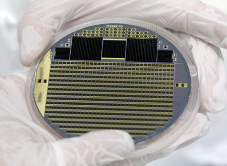 Solar cell wafer with four-junction concentrator cells and test structures.