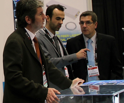 Route des Lasers members discuss opportunities at an exhibition.