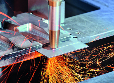Laser cutting head with diamond optics has water cooling and shield gas supply. 