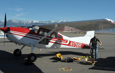 Right angle: setting up the LiDAR in the plane for a flight over Yellowstone Lake.