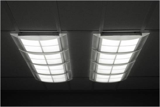 The four-panel ceiling lamp developed by Armstrong and UDC. At the Society for Information Display (SID) conference this summer, UDC said that the 15 cm x 15 cm panels used in the ceiling lamp emit a warm-white light with a color rendering index (CRI) of 87 and a correlated color temperature (CCT)
of 3055K. Credit: UDC/Armstrong.
