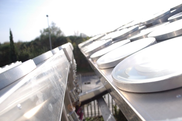Unlike most other companies working on CPV systems, Solergy uses an all-glass lens, which it claims offers much better durability than plastic alternatives at a similar cost. Systems provided by Amonix, the most advanced CPV company in terms of installations, use an acrylate-based Fresnel lens to concentrate light instead. Credit: Solergy.