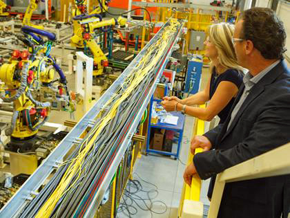 Carolyn Garvey and Don Leslie, Co-CEOs of Prodomax, watching a production line. Image: Jenoptik.