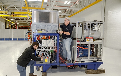 Even with the recent advances in laser diode and fiber laser efficiencies, the 100kW weapon will dissipate a colossal amount of heat. This new power and thermal management system from Libertyworks is said to be capable of handling the 300kW instant-on electrical power needed by the laser, plus the 200kW thermal load, inside a footprint that can fit on the back of a truck. Photo: Rolls-Royce Libertyworks.