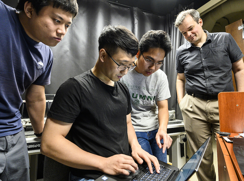 Brilliant corners: Xiaochun Liu, Ji-Hyun Nam and Toan Le work with assistant professor and principal investigator Andreas Velten (right) in the Computational Optics lab. Their project is designed to create non-line-of-sight images using reflected laser light. Photo: Bryce Richter.
