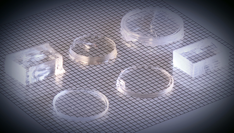 Array of polished, 3D printed gradient refractive index lenses made of titania-doped silica glass. Grid squares are 1 millimeter on each side. Image: LLNL.
