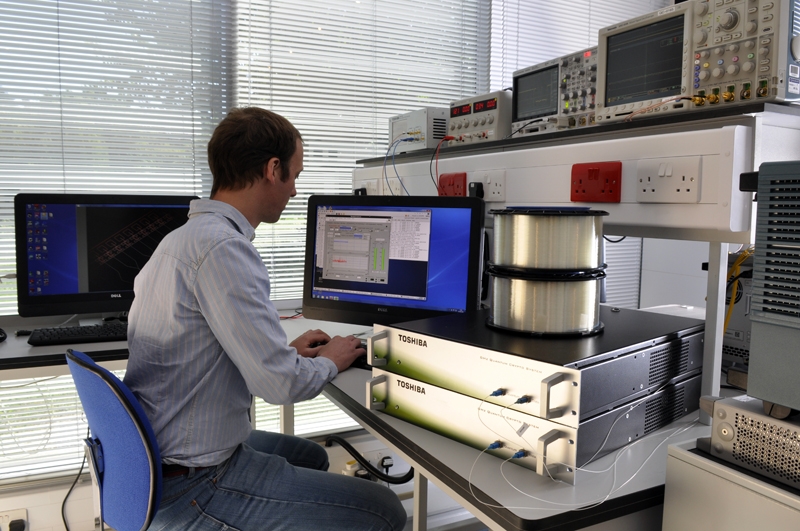 Toshiba Europe has been at the forefront of QKD hardware development for several years. Now, the technology has been shown to work over conventional optical fiber, with the potential to operate over links up to 120 km long. Other partners in the UK demonstration are working to shrink QKD hardware dramatically, potentially making it compatible with hand-held devices. Photo: Toshiba Europe.