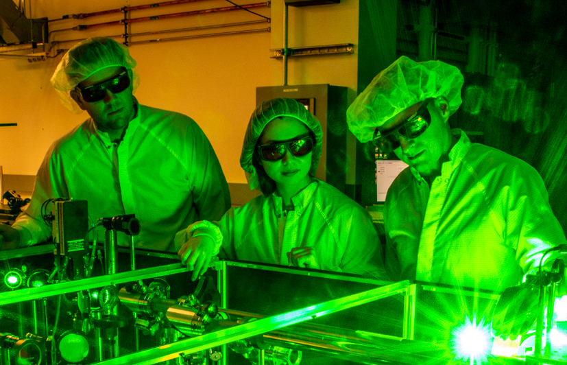 <cap1>Berkeley Lab doctoral student Fumika Isono (center), BELLA Center Deputy Director Jeroen van Tilborg (right), and research scientist Sam Barber set up a novel laser stabilization experiment at one of the BELLA Center's 100-TW-class lasers. Photo: Marilyn Sargent/Berkeley Lab.