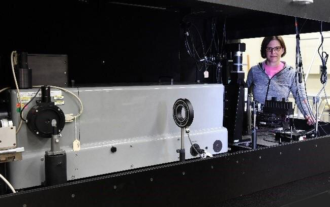 Catherine Cooksey with the upgraded transmittance calibration system. Credit: NIST.
