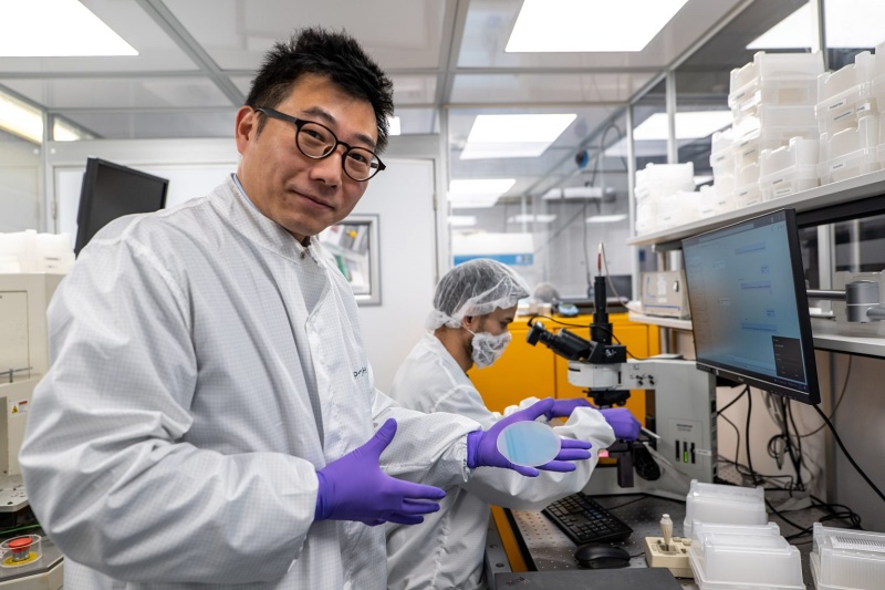 Porotech CEO Tongtong Zhu, holding an epiwafer based on the company's novel porous gallium nitride material. The wafers can be engineered to emit light at red, green, and blue wavelengths - offering a much simpler way to integrate full-color microdisplays for AR/VR glasses. Photo: Porotech.