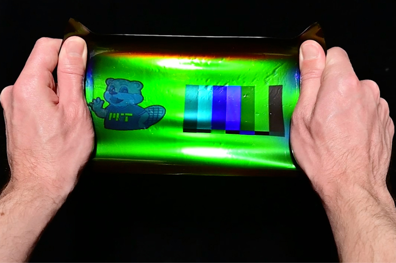 By applying a 19th-century color photography technique to modern holographic materials, an MIT team has printed large-scale images onto elastic materials that when stretched can transform their color, reflecting different wavelengths as the material is strained. Image courtesy of MIT researchers.