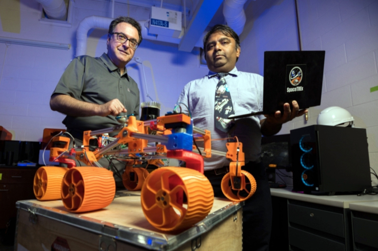 UArizona engineering faculty members Jekan Thanga (right) and Moe Momayez with a 3D-printed rover prototype with miniature sensors for use in lunar mining. Photo: Chris Richards/University of Arizona.