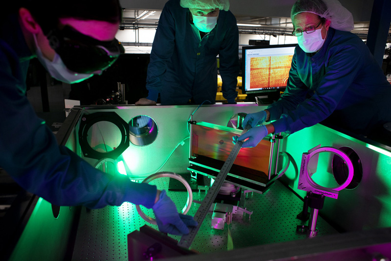 
<cap 1> (From left) Laser engineer Lauren Weinberg, research scientist John Nees and research engineer Galina Kalinchenko pose for photos while working on the ZEUS laser at the NSF ZEUS laser facility in a Michigan Engineering lab. Image credit: Marcin Szczepanski, Michigan Engineering.