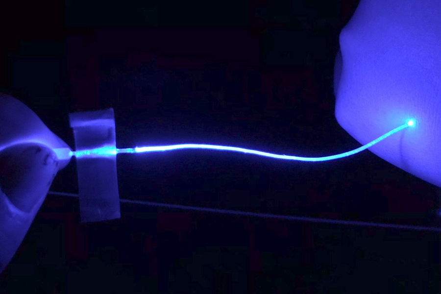 MIT engineers have designed a soft hydrogel optical fiber (shown illuminated) that stimulates peripheral nerves, and could help researchers in identifying the origins and treatments for nerve-related pain. Credit: MIT.