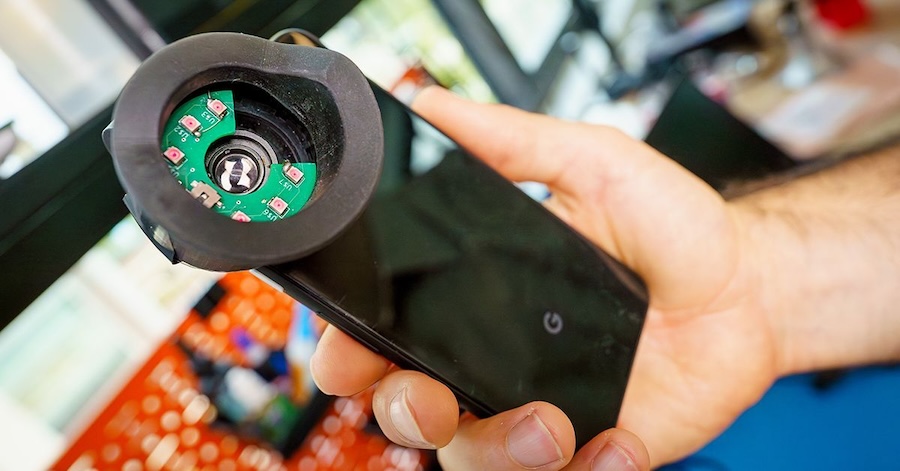This attachment fits over a smartphone's camera to capture clear video of pupil size changes, which can offer clues about an individual's neurological functions. The device helps the camera see the pupil easily in dark eye colors. Credit: David Baillot/UC San Diego Jacobs School of Engineering.