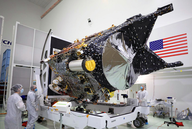 NASA's Psyche spacecraft is shown in a clean room at the Astrotech Space Operations facility near the agency's Kennedy Space Center in Florida on Dec. 8, 2022. DSOC's gold-capped flight laser transceiver can be seen, near center, attached to the spacecraft. NASA/Ben Smegelsky.
