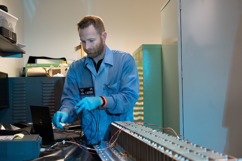 Christopher DePuma, U.S. NRL electronics engineer, conducts a functional test of the laser power beaming link on Space Wireless Energy Laser Link (SWELL) in Washington, D.C. U.S. Navy photo by Jonathan Sunderman.