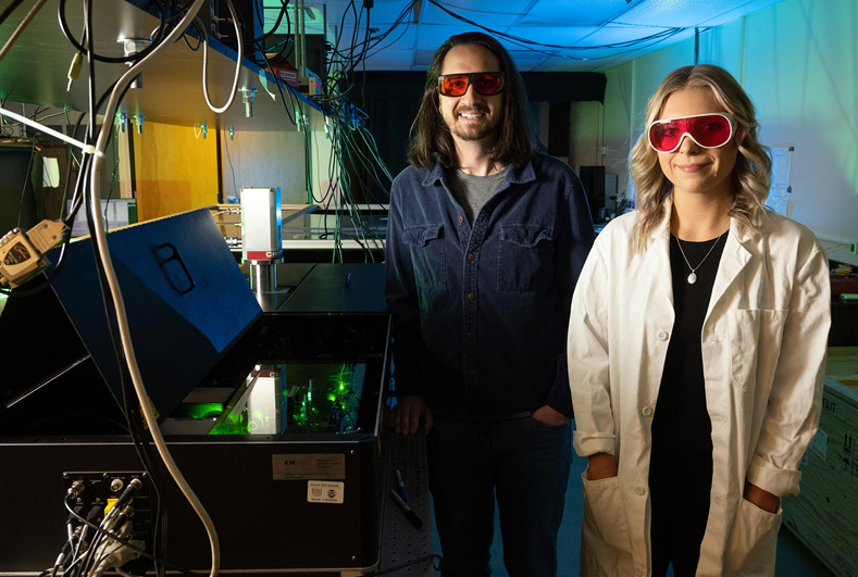 CSU researchers Yusef Farah and Rachelle Austin with the ultrafast pump-probe transient absorption spectrometer they used to measure charge carrier properties of molybdenum disulfide thin films. Photo by John Eislele.