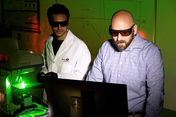 Robert V. Chimenti (right), Rowan University photonics program coordinator, and Jamison Engelhardt, a doctoral student in Materials Science & Engineering, work in the photonics lab at Rowan University's Advanced Materials & Manufacturing Institute. Photo credit: Rowan University.