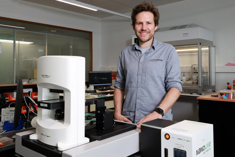 Yann Cotte with a microscope developed by his startup Nanolive. Photo: Alain Herzog / EPFL.