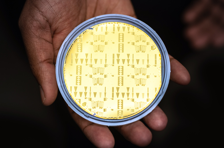 More than a thousand experimental lasers and amplifiers adorn a three-inch, gold-electroplated silicon wafer made at Sandia National Laboratories' Microsystems Engineering, Science and Applications complex. Photo credit: Craig Fritz.