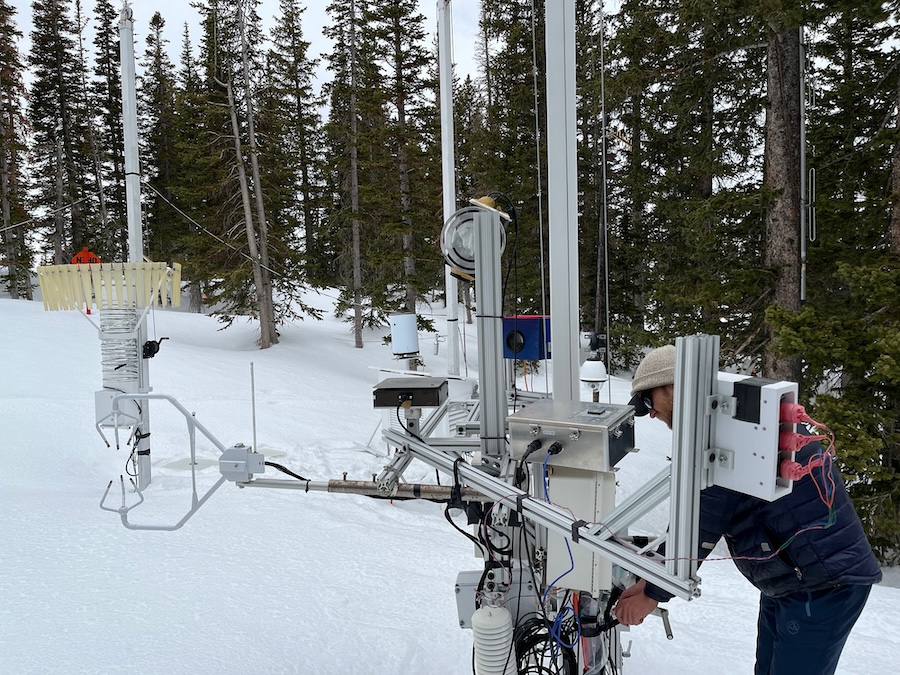 Graduate student Ryan Szczerbinski examines instrumentation called a Differential Emissivity Imaging Disdrometer, or DEID, developed by University of Utah researchers and installed at Alta near the top of Little Cottonwood Canyon. The equipment measures the hydrometeor mass, size and density of snowflakes. Credit: Tim Garrett/University of Utah.