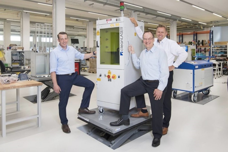 Cleaning up: cleanLASER managing director Edwin B&uuml;chter (at rear) and colleagues with one of the firm's laser cleaning systems. Photo: cleanLASER.