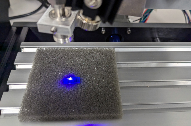 Electric blue: an LED chip under the photoluminescence mapping system. Credit: Markus Pristovsek / Nagoya University.