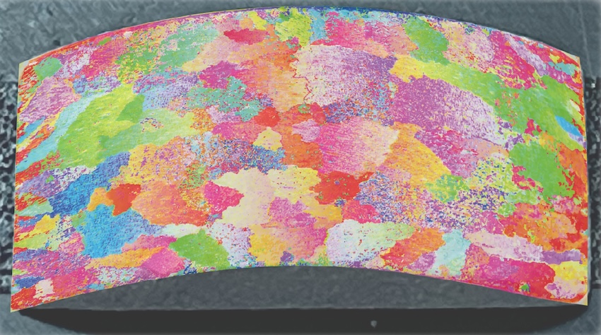A curved sample of polycrystalline aluminium seen through directional reflectance microscopy (DRM). In contrast to conventional characterisation techniques, DRM enables microstructure analysis on non-flat surfaces. Credit: Chenyang Zhu/University of Cambridge.