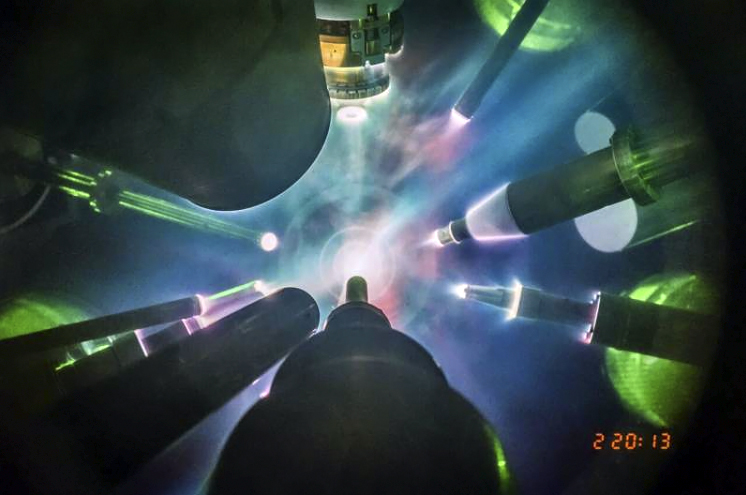 View from inside the OMEGA target chamber during a direct-drive inertial fusion experiment at the Laboratory for Laser Energetics. Scientists fired 28 kilojoules of laser energy at small capsules filled with deuterium and tritium fuel, causing the capsules to implode and produce a plasma hot enough to initiate fusion reactions between the fuel nuclei. University of Rochester Laboratory for Laser Energetics photo / Eugene Kowaluk.