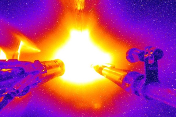 Colorized image of a deuterium-tritium (DT) target implosion at NIF, captured back in 2016 - six years before the giant 192-beam experiment first achieved fusion with energy gain. Startup Longview, with former NIF director Edward Moses at the helm, is now working with construction giant Fluor to design a commercial power plant using the same approach, but with much more modern and efficient lasers. Image: NIF/LLNL/Don Jedlovec.
