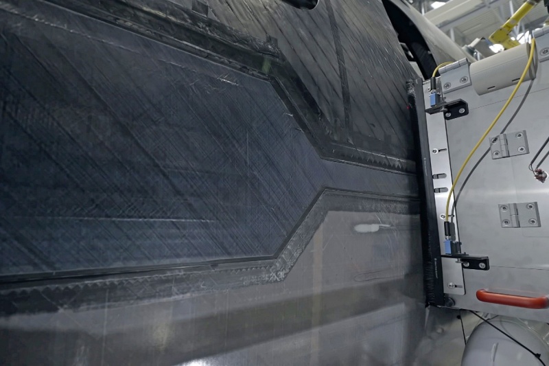On the left side of the MFFD, the longitudinal butt-strap joint between the upper and lower halves of an eight by four meter section of 