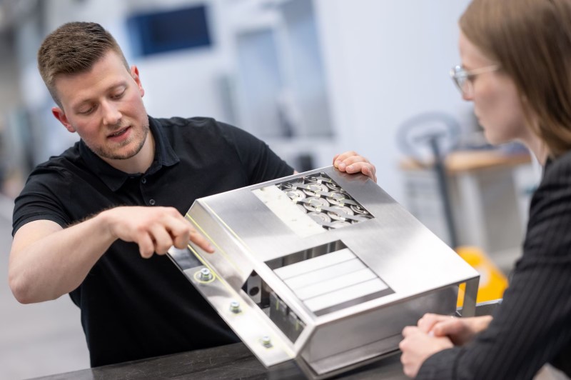 A Trumpf employee explains where the battery will be cut open by the laser. Credit: Trumpf.