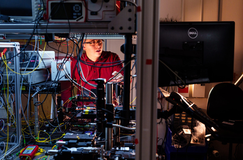 Sandia National Laboratories physicist Nils Otterstrom works to align an integrated photonics chip at the quantum photonics lab. It's part of ongoing work with Arizona State University to combine the power of integrated photonics and frequency-bin quantum information processing. Recently, Sandia awarded $17 million in Laboratory Directed Research and Development funds to take this work to the next level. (Photo by Craig Fritz) Click on the thumbnail for a high-resolution image.