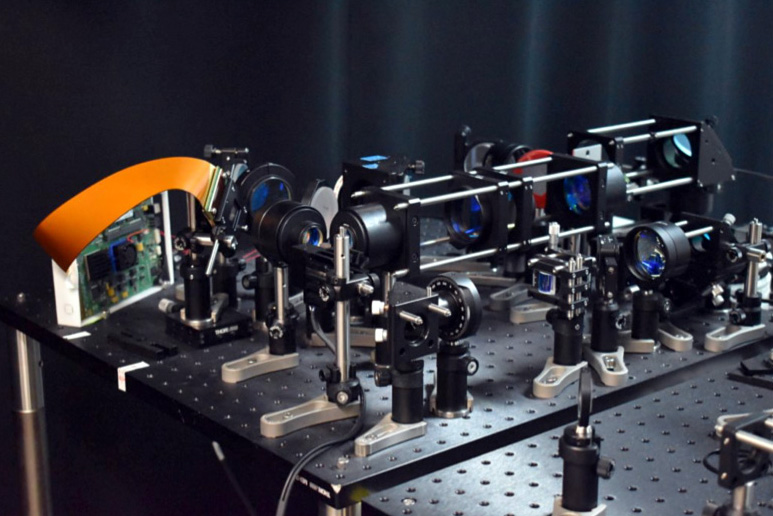 The experimental setup shows the optical components, including the DMD and beam scanners, for the two-photon microscope with the adaptive line-excitation scheme.
Credit: Molly M Bechtel, University of California, Davis.