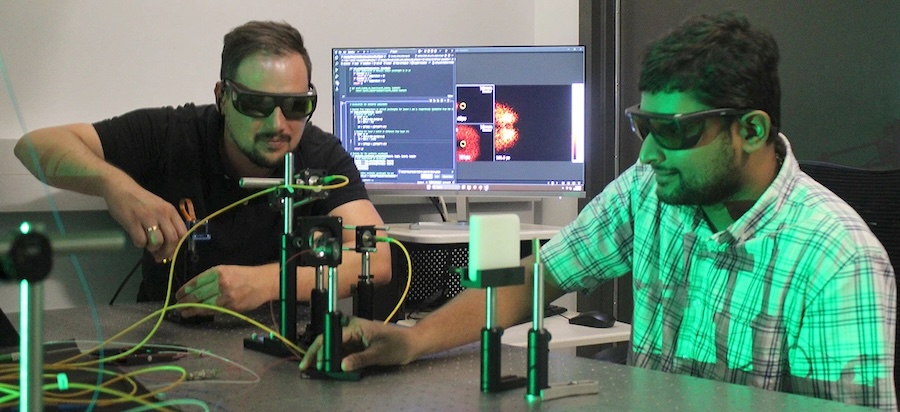 Florian Willomitzer (left) and Madabhushi Balaji align their Synthetic Wavelength Imaging lab bench prototype to image non-melanoma skin cancer. The final prototype will be implemented in a portable fashion to enable the first in vivo studies in humans. Credit: Parker Liu, University of Arizona.