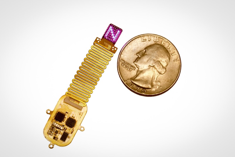 Roughly the size of a postage stamp and thinner than a credit card, the new device is less invasive than those developed previously by the team. Instead of extending into the brain through a tiny cranial defect, the new soft, flexible device conforms to the surface of the skull and shines light through the bone. Credit: Mingzheng Wu of the Rogers Research Group/Northwestern University.