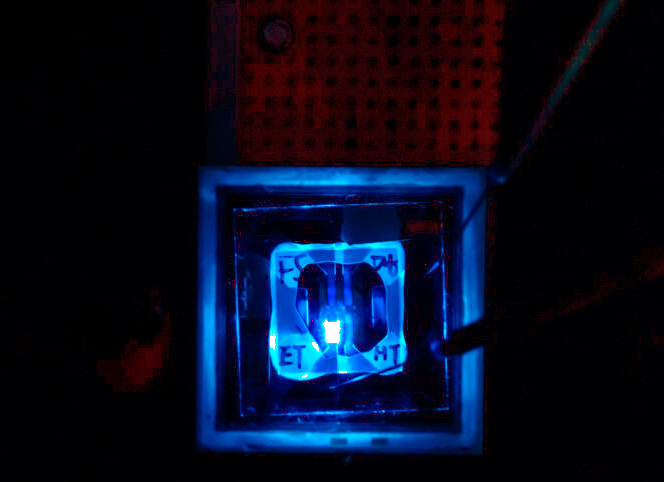 The PHOLED glows blue. The new device, developed in the lab of Steve Forrest at the University of Michigan, shows a pathway for efficient blue OLEDs that can last as long as the efficient green and red OLEDs already in high end televisions and flagship smartphone displays. Credit: Jero Lopera, Electrical and Computer Engineering, University of Michigan.