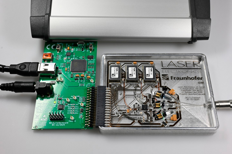 Demonstration unit created in the QuantumCascade project. The thin-glass board developed and constructed at Fraunhofer IZM measures 80 by 100 mm and includes integrated lasers and drivers that can be controlled via a customizable interface. &copy; Gunnar B&ouml;ttger.