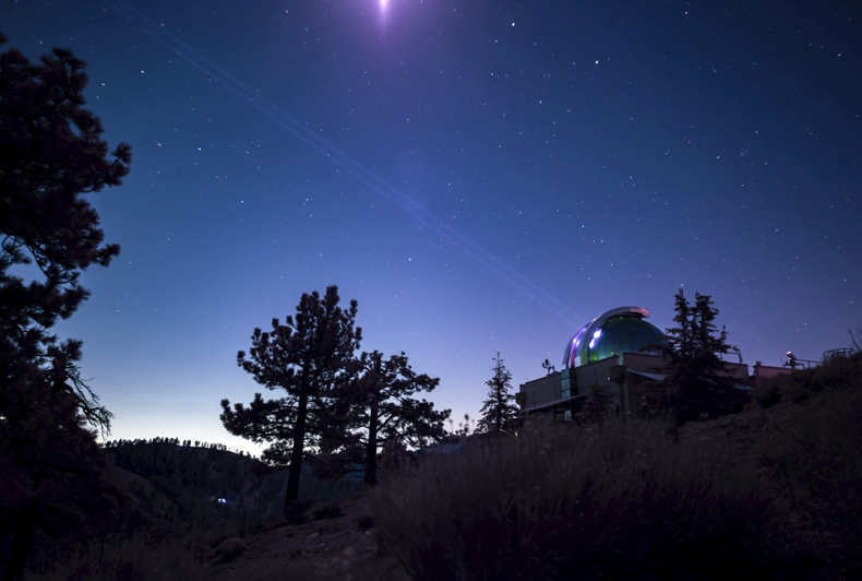 The Optical Communications Telescope Laboratory at JPL's Table Mountain Facility near Wrightwood, California, beams its eight-laser beacon to the Deep Space Optical Communications flight laser transceiver aboard NASA's Psyche spacecraft. NASA/JPL-Caltech.