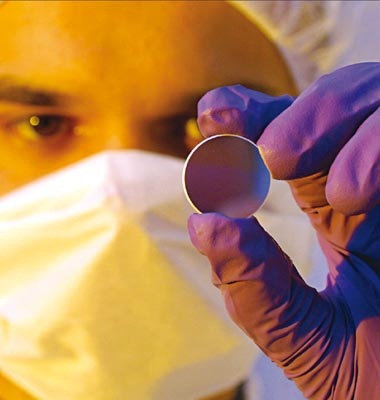 The laboratory for attosecond physics at Garching produces chirped multilayer mirrors for its research. Volodymyr Pervak is seen examining the mirrors. Credit: Thorsten Naeser.