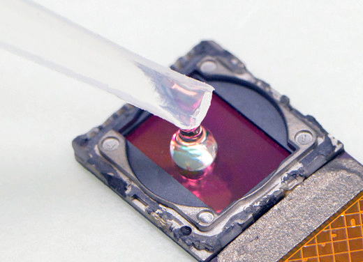 Cell-phone! The test sample is placed directly on the exposed surface of the image sensor chip (from a standard phone camera) after the removal of the optics. Photograph: Heli Vilmi.