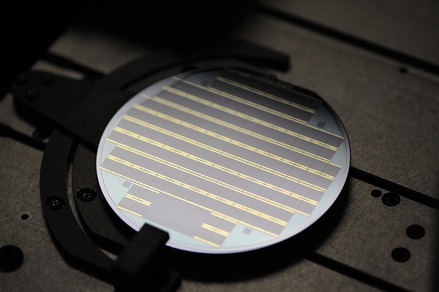 This image shows a wafer full of high-efficiency III-V solar cells, manufactured using MBE deposition by the US firm Solar Junction, which holds the world record for cell conversion efficiency at just over 44%. The UCL-Bristol team is aiming to make cells with good efficiencies but which can be manufactured much more cheaply by employing silicon wafers. Credit: Solar Junction.