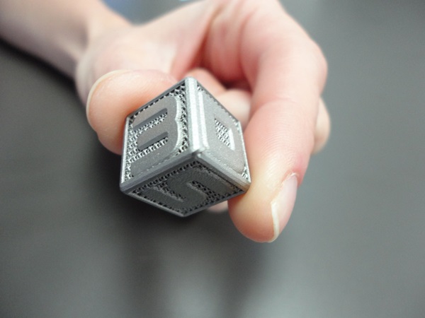 Much of the recent hype around 3D printing surrounds low-cost, non-laser technologies like extrusion, but additive production of metal components such as the cube shown here are generally made with laser-based tools. Credit: 3D Systems.