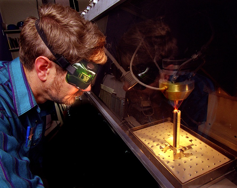 Laser engineered net shaping (LENS) was developed several years ago by a research team at Sandia National Laboratories. Optpmec, based in nearby Albuquerque, commercialized the technology and has been selling LENS systems since 1998. Photo: Randy Montoya/Sandia. 