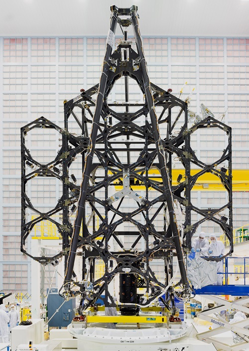 The folding structure of the JWST mirror backplane, to which the 18 gold-coated segments of the primary mirror are now being attached. The mirror will be unfurled once the JWST is in position a million miles from Earth after its planned October 2018 launch. Photo: NASA.