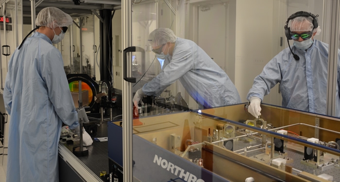 LLNL's Thomas Spinka (left) and Andy Bayramian and Donald Paddick of Northrop Grumman Cutting Edge Optronics install the Gigashot-HE laser in the HAPLS laser system under construction in Bldg. 381. Photo: LLNL.