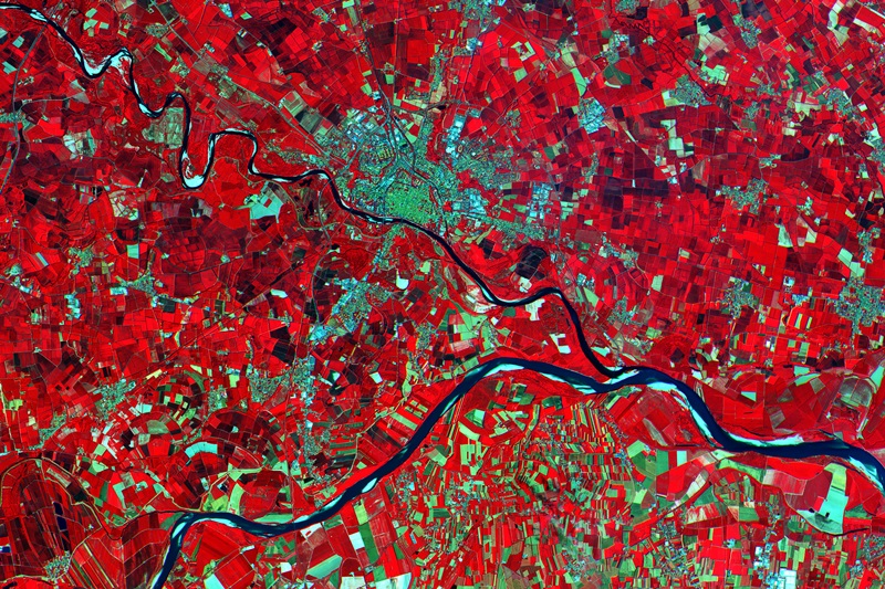 Close-up of an area in the Po Valley - showing Pavia (center) and the confluence of the Ticino and Po rivers. This is a subset from the first image captured by the Sentinel-2A satellite, acquired on 27 June 2015 at 10:25 UTC (12:25 CEST) and only four days after launch. Processed using the high-resolution infrared spectral channel, the satellite's instrument will provide key information on crop type and health, assist with food security activities, and could also help authorities monitor illegal gouging of sand and gravel from the river. Image: ESA/Copernicus.